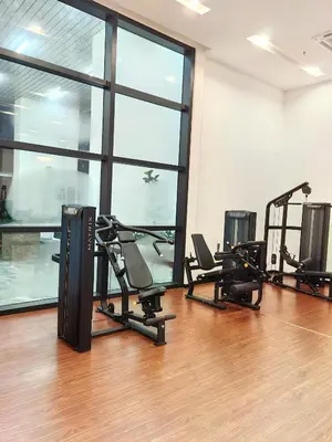 a gym with treadmills and ellipticals in a room with windows at Chambers Residence KLCC By Purple Orchid in Kuala Lumpur