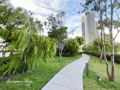 a walkway in a park with a tall building at Trion @ KL By Awesomestay in Kuala Lumpur