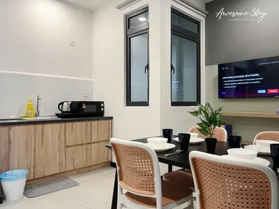 a dining room with a table and chairs at Neu Suites By Awesomestay in Kuala Lumpur