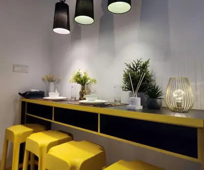 a restaurant with yellow stools and a counter at Arte Plus Kuala Lumpur by Inn Lux in Kuala Lumpur