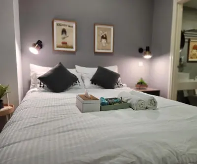 a bedroom with a large bed with a white bedspread at Arte Plus Kuala Lumpur by Inn Lux in Kuala Lumpur