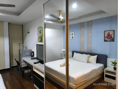 a bedroom with a bed and a desk with a computer at Sweet Home-0263A-Casa Residency in Kuala Lumpur