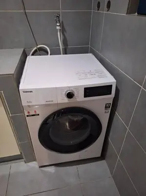 a washing machine in a corner of a bathroom at 026-3A Sweet Home-Casa Residency 2R 2B in Kuala Lumpur