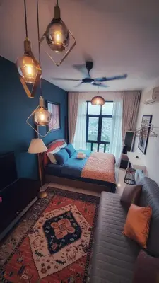a bedroom with a bed and a couch at King Studio Suite Legasi Kampung Bharu view KLCC in Kuala Lumpur