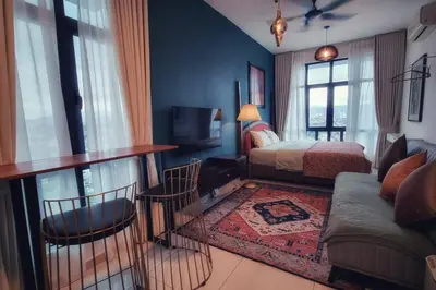 a bedroom with a bed and a table and chairs at King Studio Suite Legasi Kampung Bharu view KLCC in Kuala Lumpur