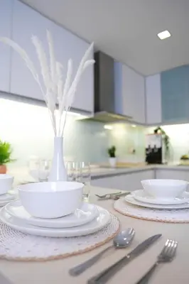 a table with plates and utensils on a kitchen counter at 7 PAX, 1BR, 3mins to KLCC (3A3A) in Kuala Lumpur