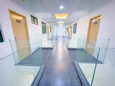 a hallway with glass doors and a tiled floor at StarQ Hotel Bukit Bintang in Kuala Lumpur