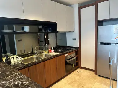 a kitchen with a sink and a stainless steel refrigerator at Anggun KL MY in Kuala Lumpur