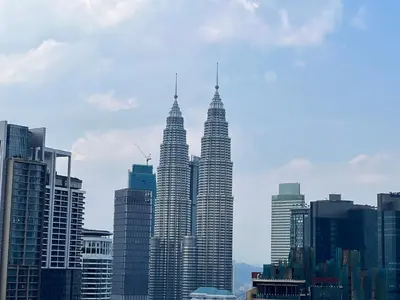 a view of the petronas towers in a city at Anggun KL MY in Kuala Lumpur