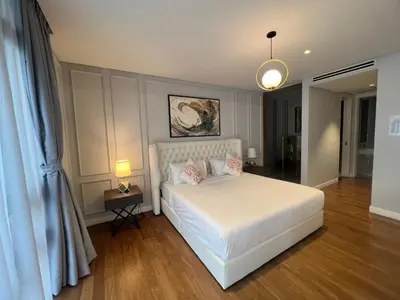 a bedroom with a white bed with pink pillows at Anggun KL MY in Kuala Lumpur