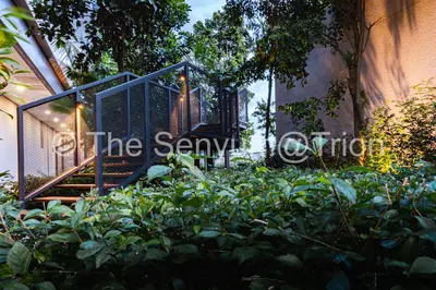 a house with a gate and stairs in a garden at TRION Studio 4 PAX Teneleven in Kuala Lumpur