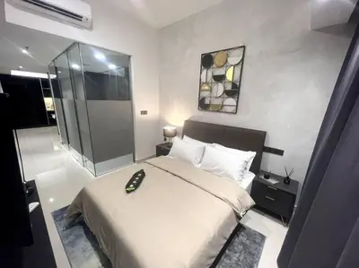 a bedroom with a large bed and a glass shower at Novo KL, Astonishing Unique Executive Suite in Kuala Lumpur
