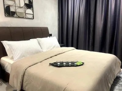 a pair of glasses sitting on top of a bed at Novo KL, Astonishing Unique Executive Suite in Kuala Lumpur