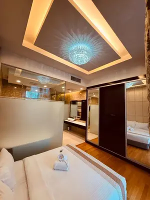 a bedroom with a large bed and a bathroom at Dorsett Infinity Pool KL in Kuala Lumpur