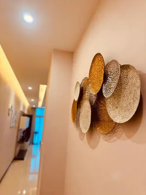 a group of straw hats hanging on a wall at Dorsett Infinity Pool KL in Kuala Lumpur