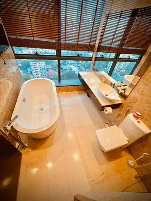 a bathroom with a toilet and a sink with a window at Dorsett Infinity Pool KL in Kuala Lumpur