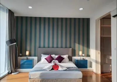 a bedroom with a bed with a teddy bear on it at The Platinum KLCC By Classy in Kuala Lumpur