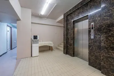 a room with a hallway with a door and a table at Grand Orchard Hotel Premier in Kuala Lumpur