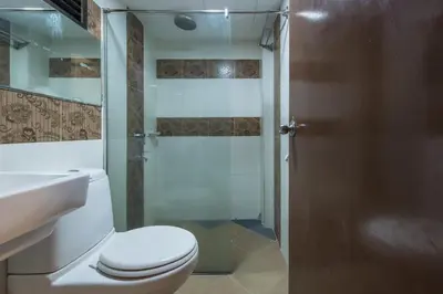 a bathroom with a toilet and a shower at Grand Orchard Hotel Premier in Kuala Lumpur