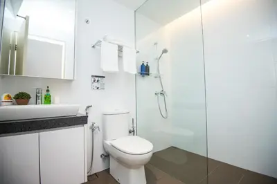 a white bathroom with a toilet and a shower at KLCC EST Bangsar By PSM in Kuala Lumpur