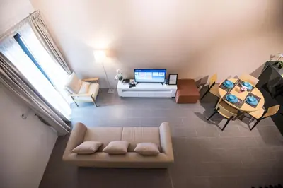 a living room with a couch and a table at KLCC EST Bangsar By PSM in Kuala Lumpur