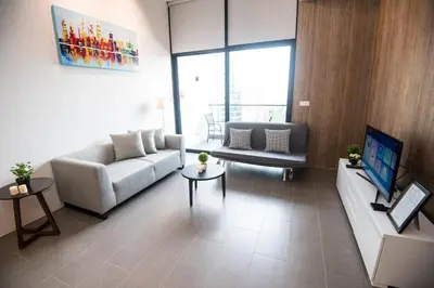 a living room with a couch and a tv at KLCC EST Bangsar By PSM in Kuala Lumpur
