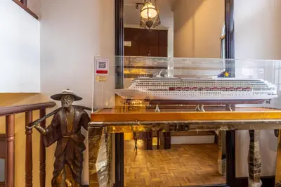 a model of a cruise ship in a display case at Bangsar Villa for groups, event space and family fun in Kuala Lumpur