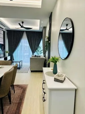 a living room with a table and a mirror at Sunset View at Modern Home in Kuala Lumpur