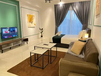 a bedroom with a bed and a couch and a tv at KL Chambers Suites BY Fortune in Kuala Lumpur