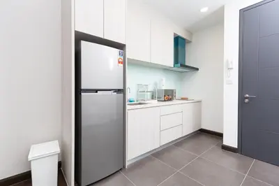 a kitchen with a stainless steel refrigerator in a room at Velocity Residence Suites By PSM in Kuala Lumpur