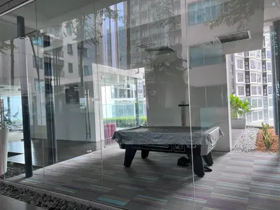 a pool table in a room with glass walls at 12mins walk to KLCC in Kuala Lumpur