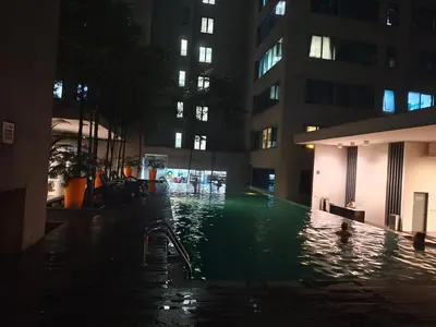 a swimming pool in a building at night at 12mins walk to KLCC in Kuala Lumpur