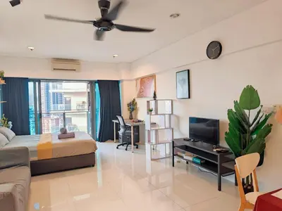 a living room with a bed and a tv at 12mins walk to KLCC in Kuala Lumpur