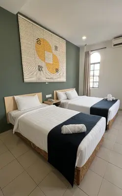 two beds in a hotel room with at Cojoy Hotel @ Chinatown in Kuala Lumpur