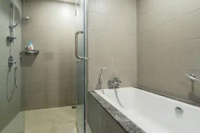 a bathroom with a bath tub and a shower at THE APARTMENT at 188 SUITES KLCC in Kuala Lumpur