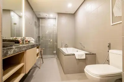 a bathroom with a toilet and a sink and a shower at THE APARTMENT at 188 SUITES KLCC in Kuala Lumpur