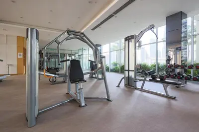 a gym with cardio equipment in a building at THE APARTMENT at 188 SUITES KLCC in Kuala Lumpur