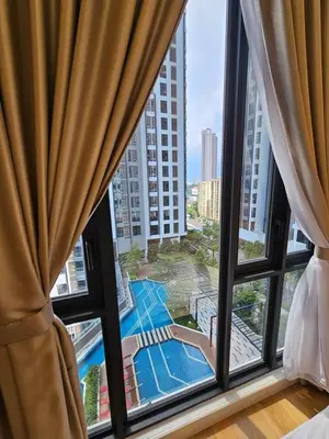 a bedroom with a view of a pool from a window at SS KL Sentral by NomadNest in Kuala Lumpur