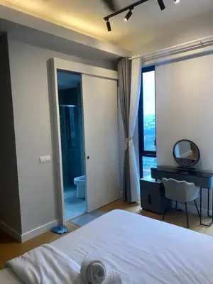 a bedroom with a bed and a mirror and a bathroom at SS KL Sentral by NomadNest in Kuala Lumpur