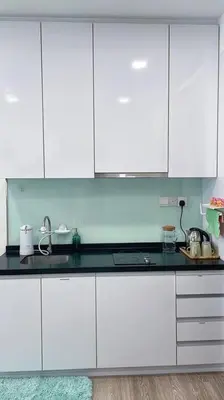 a kitchen with white cabinets and a black counter top at Premium Stay at Bukit Bintang City Centre by Premium Stay in Kuala Lumpur
