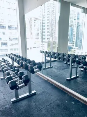 a gym with a row of chairs in front of a window at Premium Stay at Bukit Bintang City Centre by Premium Stay in Kuala Lumpur