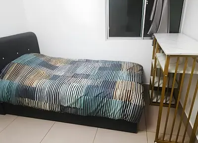 a bed and a desk in a room with a bed and a window at Razak City Centre KL SkyView 45th in Kuala Lumpur