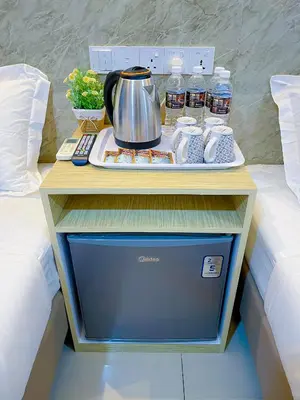 a table with a tea kettle on top of a bed at StarQ Hotel Kuala Lumpur in Kuala Lumpur