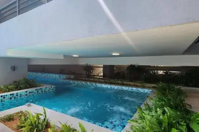 a large swimming pool with blue water in a building at Neu Suites Studio Room - 3km to KLCC, 8 mins walk to LRT in Kuala Lumpur