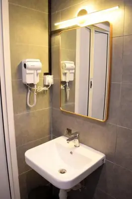 a bathroom with a sink and a mirror at Neu Suites Studio Room - 3km to KLCC, 8 mins walk to LRT in Kuala Lumpur