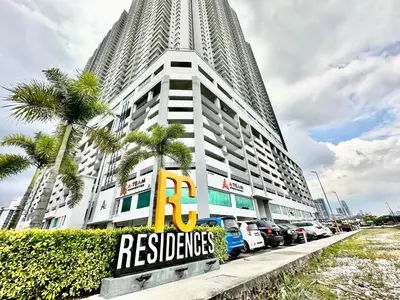 a tall building with cars parked in front of it at Razak City Residences, Sungai Besi by Rverse Suite in Kuala Lumpur