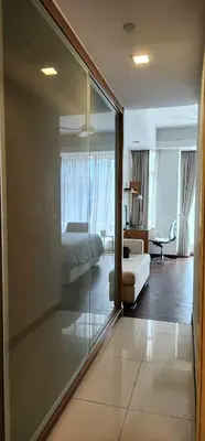 a hotel room with a bed and a glass wall at 163 SUPER KING BED STUDIO near Petronas Twin Tower KLCC KL Convention Center by Zen Glo in Kuala Lumpur
