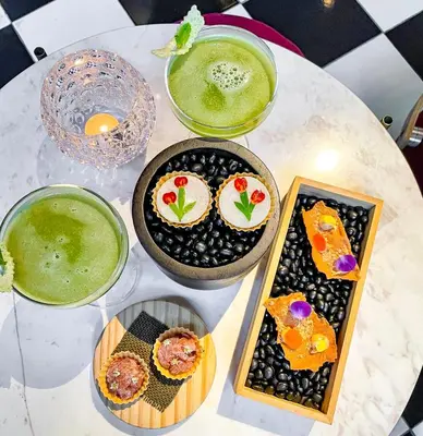 a white table topped with plates of food and drinks at 163 SUPER KING BED STUDIO near Petronas Twin Tower KLCC KL Convention Center by Zen Glo in Kuala Lumpur