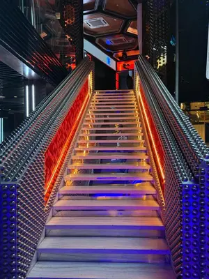 a set of stairs in a theatre with colorful lights at The Platinum KLCC by Skyline in Kuala Lumpur