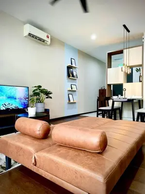 a brown leather couch in a living room at Premium Cozy Studio Near Mid Valley in Kuala Lumpur